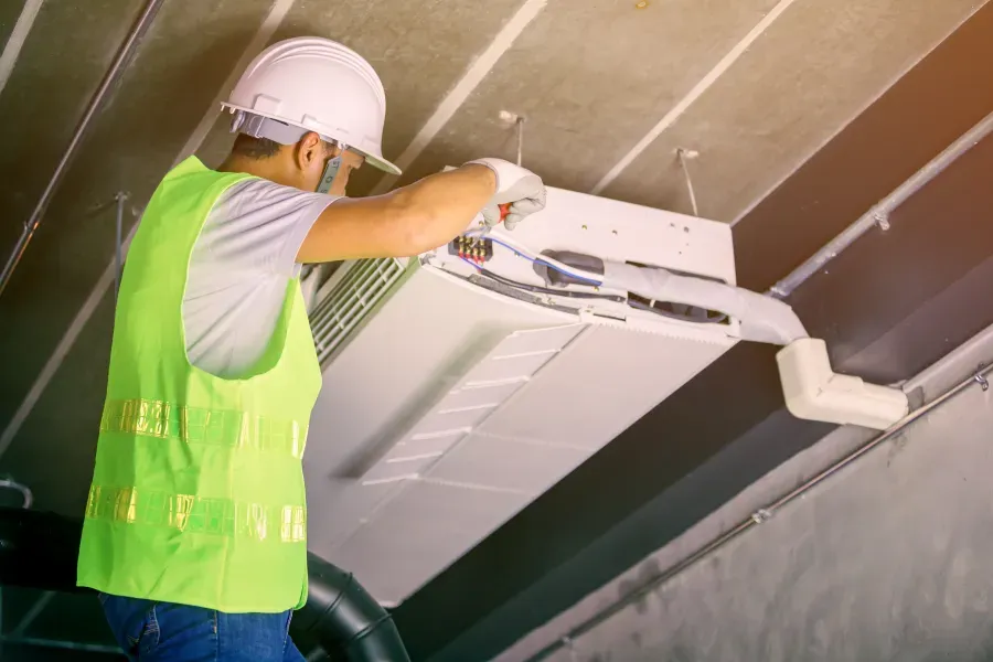 Air conditioning engineer installing commercial equipment