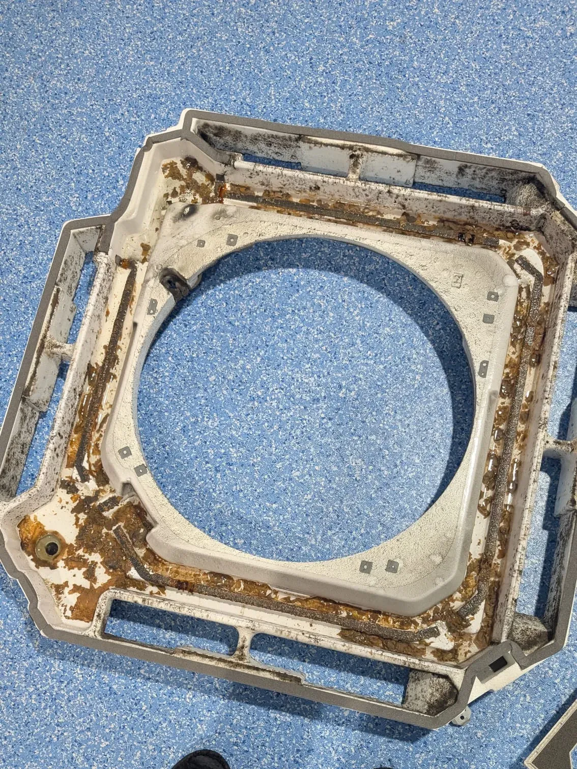 Removed ceiling cassette drain pan showing accumulated dirt and deposits